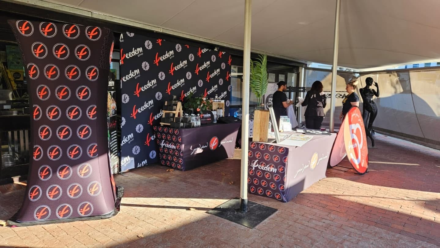 Indoor exhibition stand with printed backdrop and counter