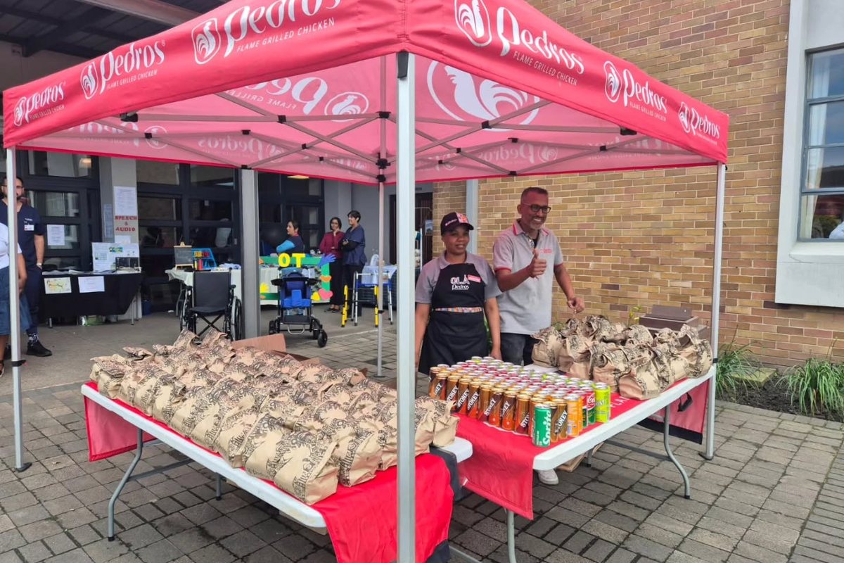 Branded market stall with a printed gazebo and product tables